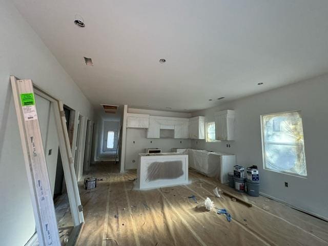 kitchen featuring a healthy amount of sunlight, light wood-style floors, and white cabinets