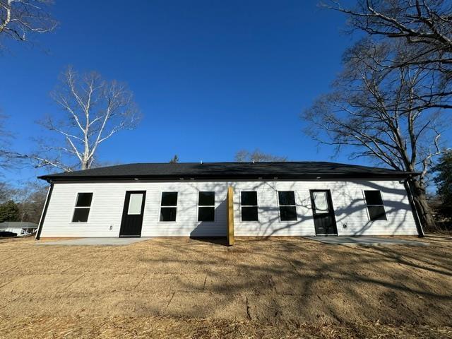 back of house with a lawn