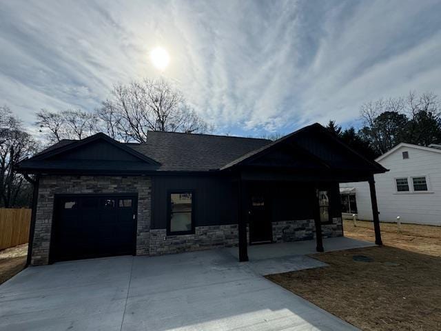 single story home with a garage, concrete driveway, and fence