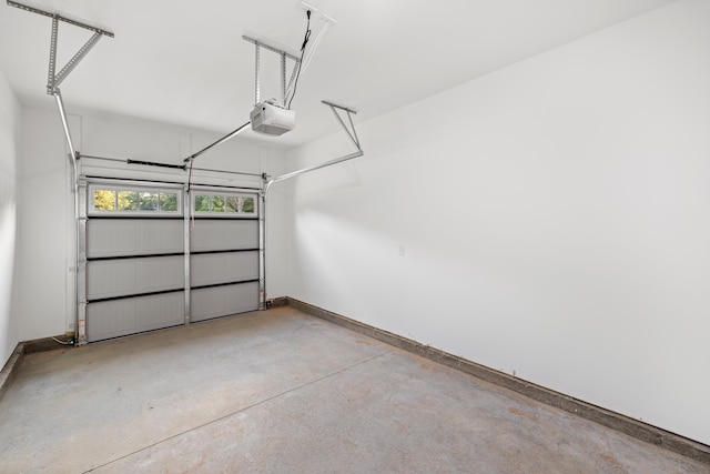 garage with baseboards and a garage door opener