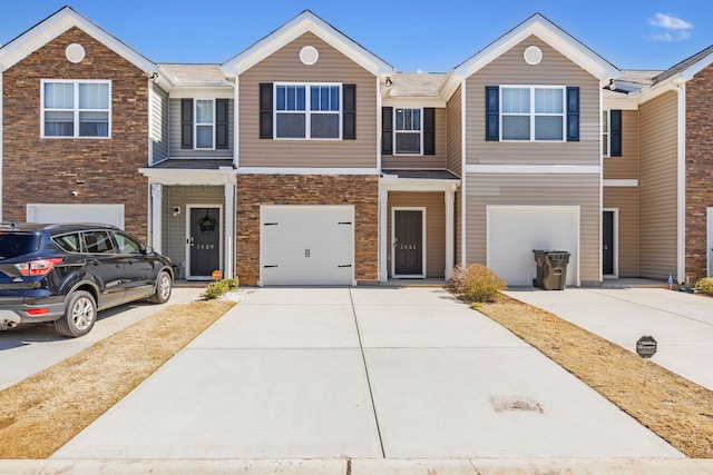 townhome / multi-family property featuring a garage and driveway