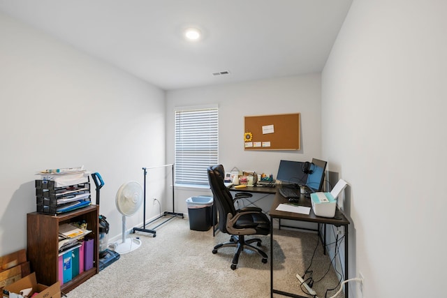 carpeted office space with visible vents and baseboards