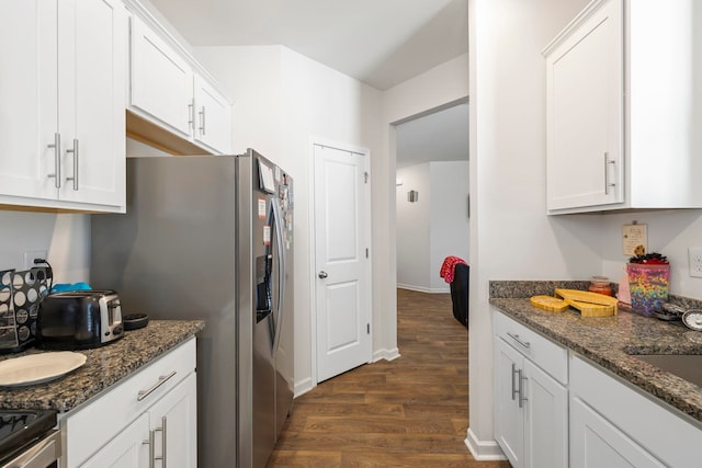 kitchen with dark wood-type flooring, dark stone countertops, electric stove, white cabinets, and a sink