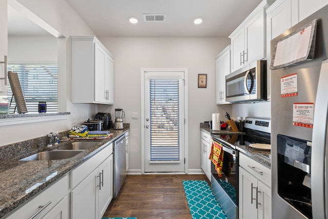 kitchen with dark wood-style floors, plenty of natural light, appliances with stainless steel finishes, and a sink