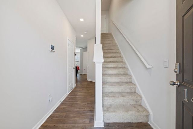 stairway with recessed lighting, baseboards, and wood finished floors