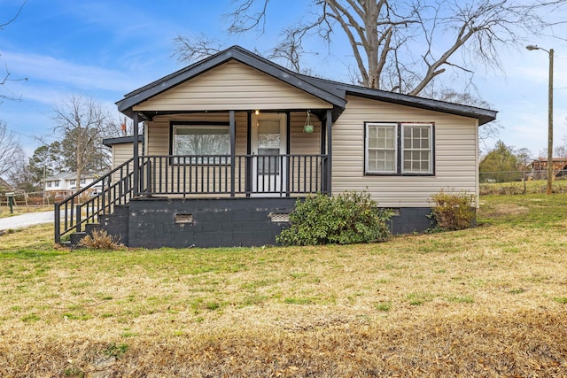 bungalow with a porch, fence, a front lawn, and crawl space