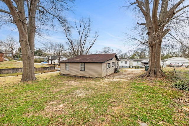 exterior space with crawl space, a lawn, and fence