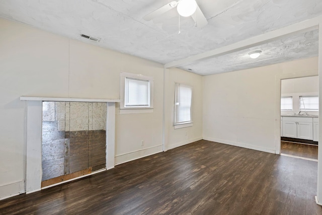 unfurnished living room with visible vents, ceiling fan, baseboards, and wood finished floors