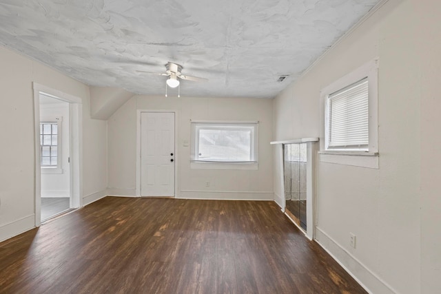 foyer featuring baseboards, a healthy amount of sunlight, and wood finished floors