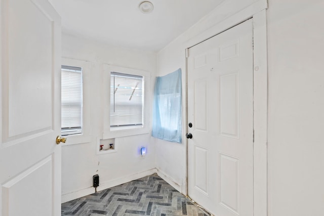 laundry area with laundry area, baseboards, and washer hookup