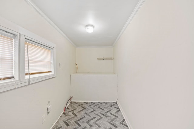 laundry room featuring crown molding and baseboards