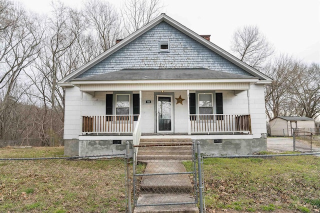 bungalow featuring a gate, a porch, a front lawn, a fenced front yard, and crawl space