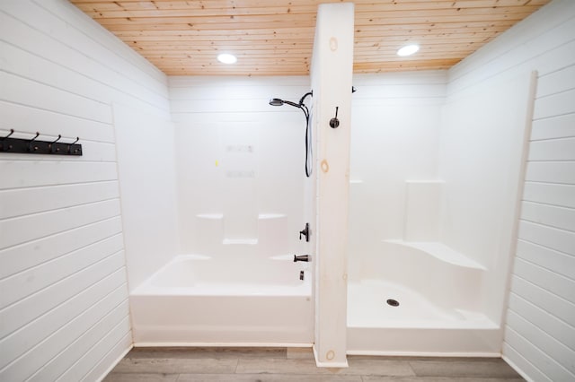 full bath featuring wood finished floors, wooden walls, a shower, wood ceiling, and a bath
