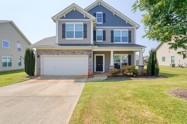 craftsman inspired home featuring a garage, board and batten siding, concrete driveway, and a front lawn