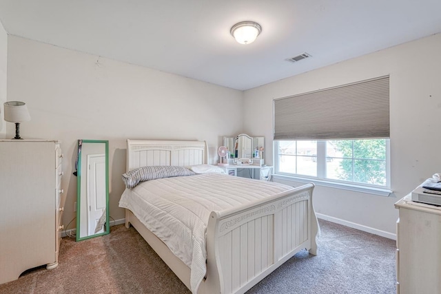 bedroom featuring visible vents, baseboards, and carpet