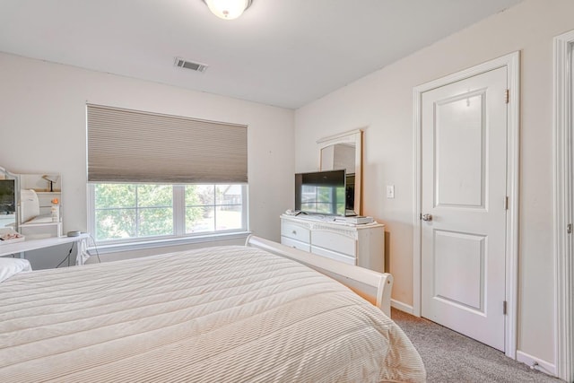 bedroom featuring light colored carpet, visible vents, and baseboards