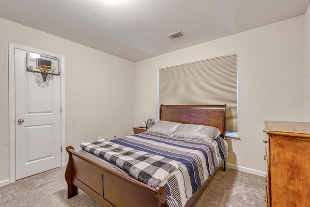 bedroom featuring visible vents, light carpet, and baseboards