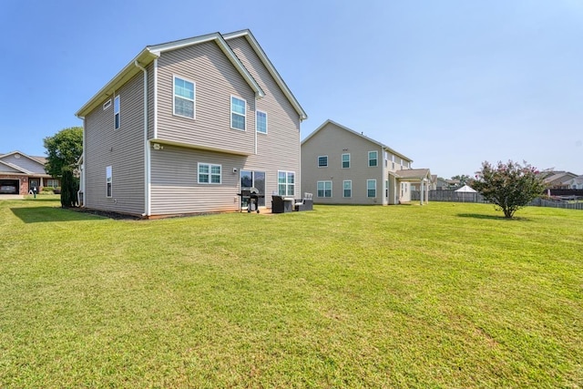 rear view of property with a yard