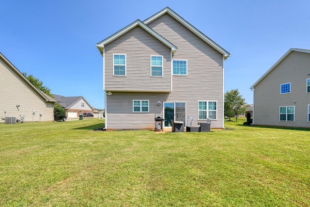 back of property featuring a yard and central AC