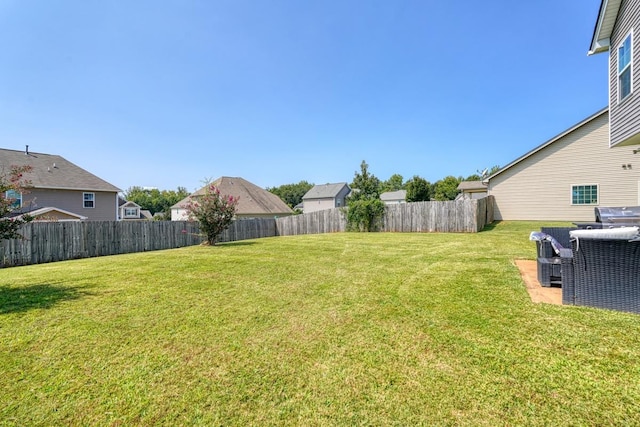 view of yard with a fenced backyard