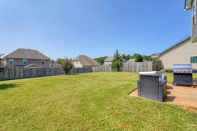 view of yard featuring a patio area and a fenced backyard