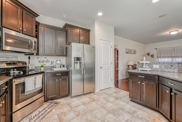 kitchen featuring dark brown cabinetry, light stone counters, recessed lighting, and appliances with stainless steel finishes