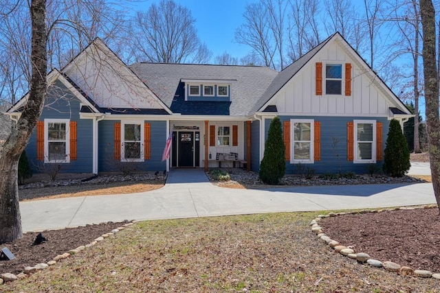 view of front of home with covered porch, board and batten siding, and a shingled roof