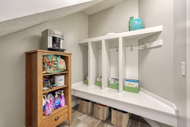 mudroom featuring a textured ceiling and wood finished floors