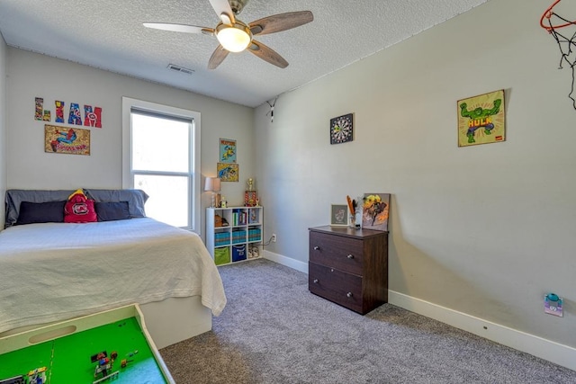 bedroom featuring visible vents, a ceiling fan, a textured ceiling, carpet flooring, and baseboards