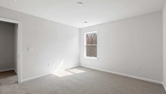 carpeted empty room with baseboards