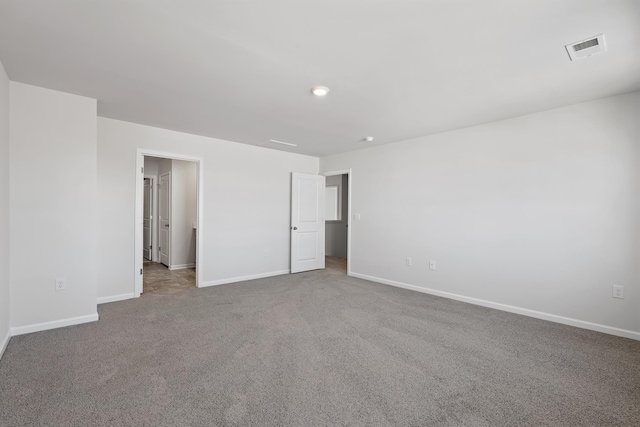 unfurnished bedroom with visible vents, carpet floors, and baseboards