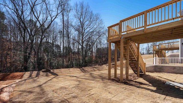 view of yard featuring stairway and a deck