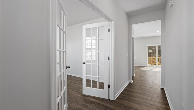 hall with dark wood-style floors, baseboards, and french doors