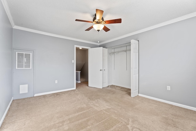 unfurnished bedroom with visible vents, baseboards, carpet floors, ornamental molding, and a closet