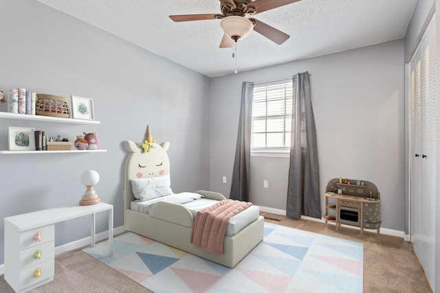 bedroom with baseboards, carpet, a closet, and a textured ceiling