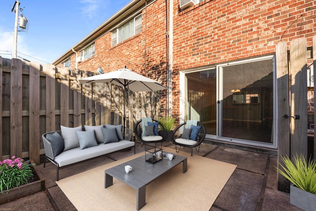 view of patio / terrace with an outdoor living space and fence