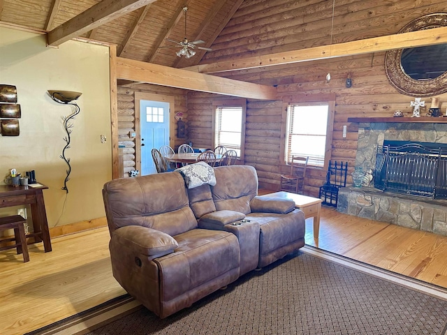 living area with beam ceiling, high vaulted ceiling, wood finished floors, wooden ceiling, and a fireplace