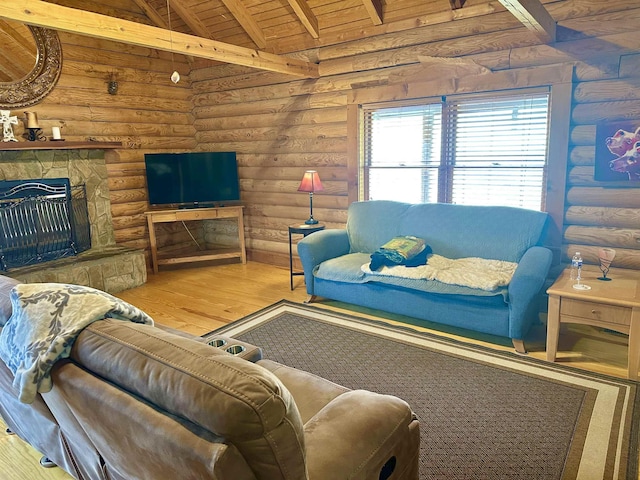 living room with lofted ceiling with beams, wood finished floors, rustic walls, a fireplace, and wood ceiling