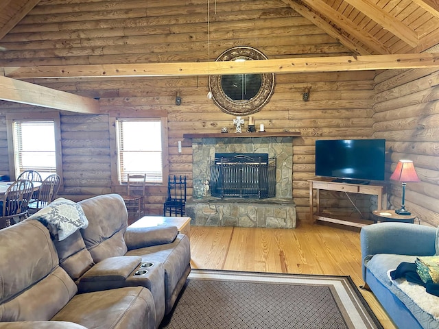 living area featuring wood finished floors, high vaulted ceiling, a stone fireplace, wooden ceiling, and beamed ceiling