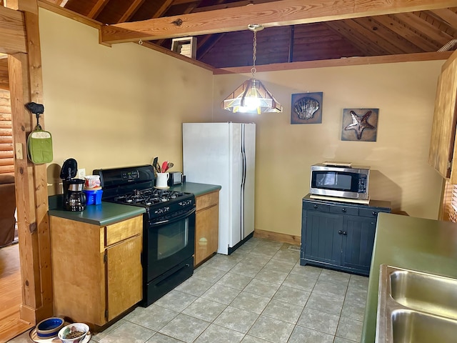 kitchen featuring stainless steel microwave, lofted ceiling with beams, light tile patterned floors, freestanding refrigerator, and gas stove