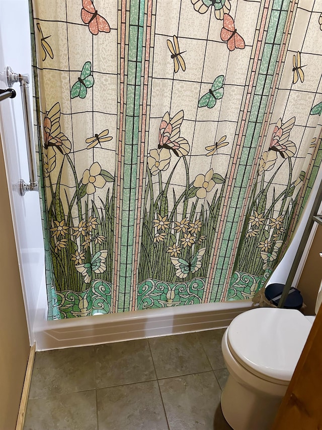 bathroom with tile patterned floors and toilet