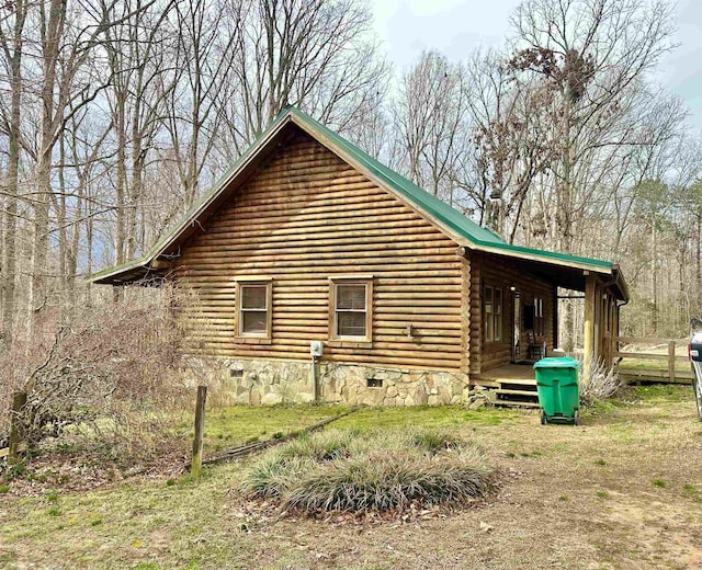 view of home's exterior featuring log siding and crawl space