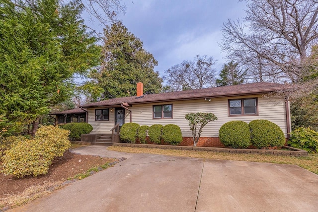 ranch-style home with a chimney