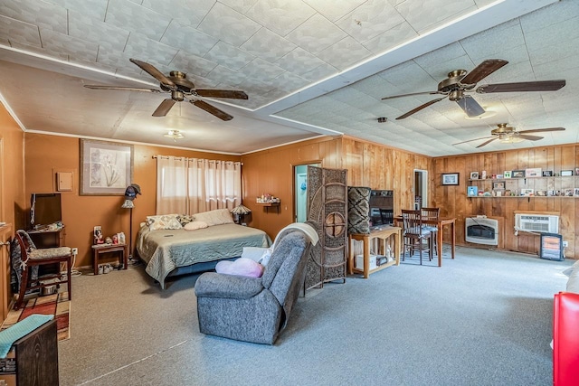 bedroom featuring heating unit, wood walls, and carpet flooring