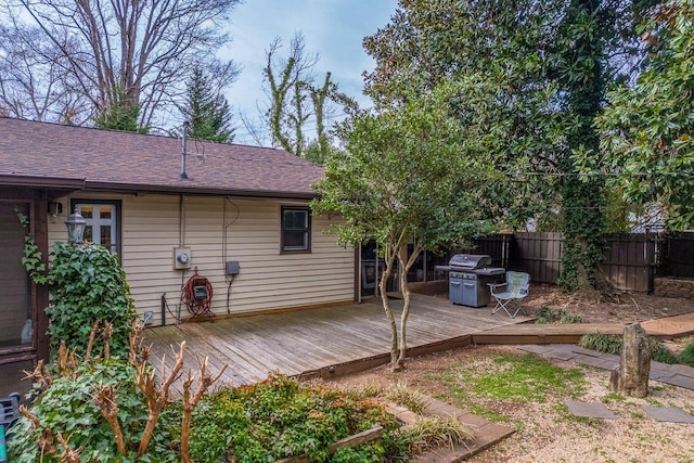 wooden terrace with area for grilling and fence