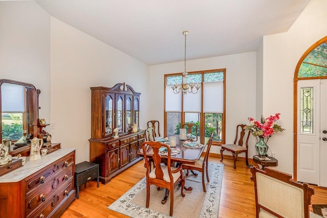 dining space with a chandelier and light wood finished floors