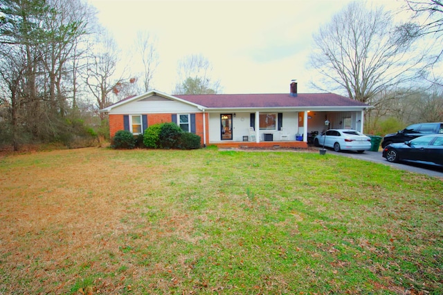 ranch-style home with brick siding, driveway, a front yard, and a chimney