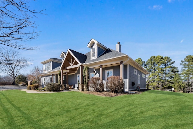 view of front of house featuring a chimney and a front lawn