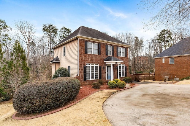 view of front of house with brick siding and driveway