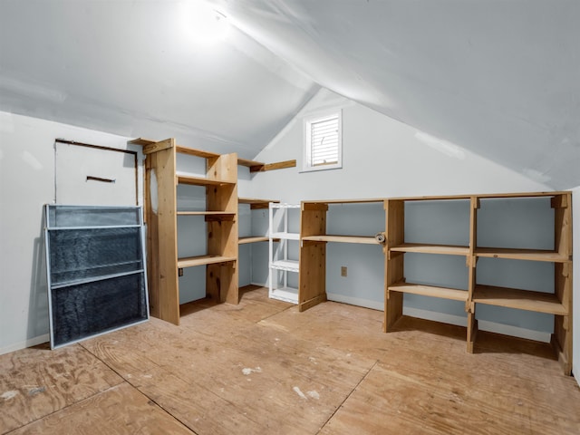 bonus room with baseboards and lofted ceiling